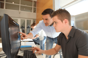 Student and teacher at computer
