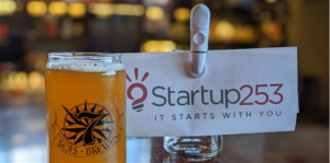 Image of a pint of beer with Startup 253's logo behind it.